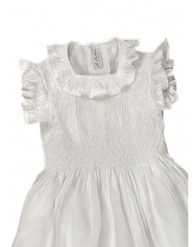 Maria sole abito per bambina con smock in lino bianco. Dettaglio.