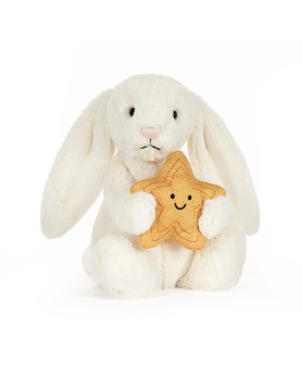 Peluche Jellycat Bashful Bunny color panna che tiene una stella dorata tra le zampe.