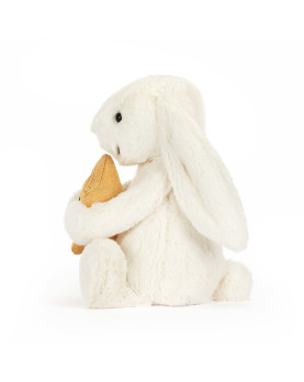 Peluche Jellycat Bashful Bunny color panna che tiene una stella dorata tra le zampe. Idea regalo